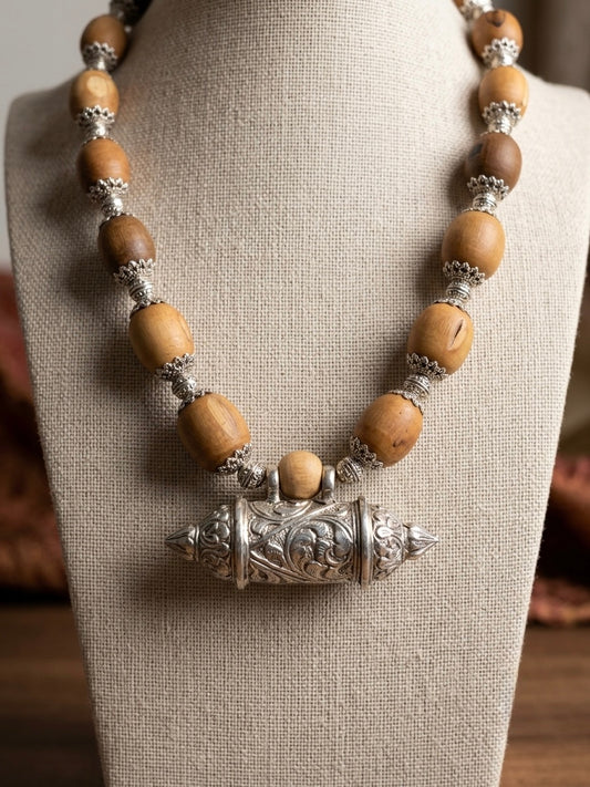 Bhaktamal kavach brown round tulsi bead kanthi mala with silver caps on a linen bust