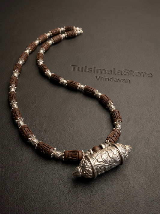 Bhaktamal kavach kanthi mala with brown carved Radha beads and silver caps on a Tulsimalastore leather mat